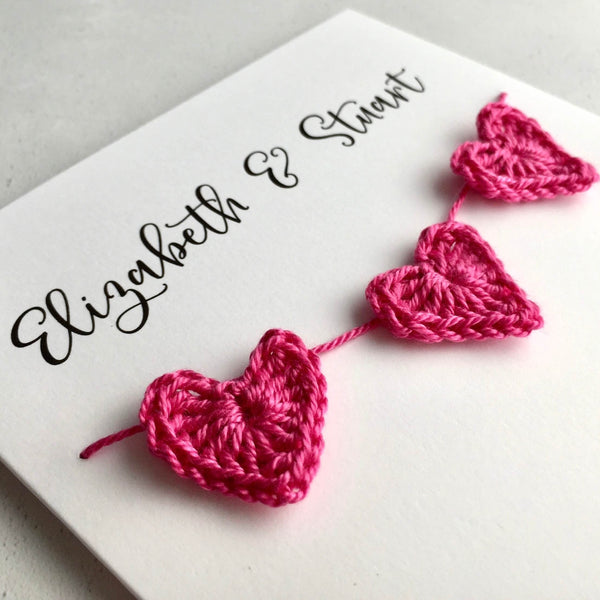Wedding card finished with 3 crochet hearts